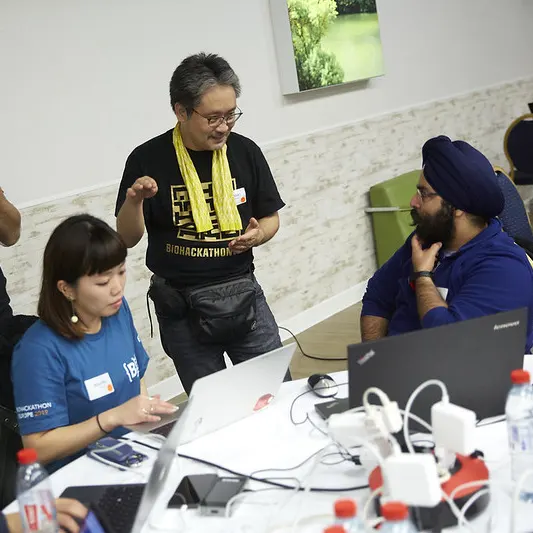 Three people discussing at a table